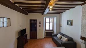 a living room with a couch and a tv at Borgo Antico in Gubbio
