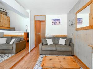 a living room with two couches and a table at Appartement rénové près des pistes avec terrasse, ski, parking et cuisine équipée - FR-1-514-48 in Courchevel