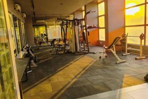 a gym with several tread machines in a room at The Ten - Cozy 2bhk in Baner in Pune