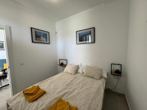a bedroom with a bed and two pictures on the wall at Casa Sofia - Costa Calma Sun & Beach in Costa Calma +7 photos