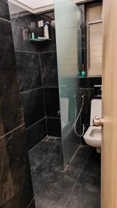 a bathroom with a shower and a toilet in it at The Ten - Cozy 2bhk in Baner in Pune