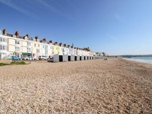 a long row of buildings on the beach at Chickerell House in Weymouth