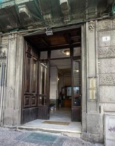 an entrance to a building with wooden doors at Luxury apartment in Naples in Naples