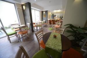 a restaurant with a table and chairs and a dining room at Hotel Boutique Reyall in Santiago