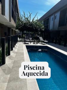 a swimming pool with a sign that reads piseria australia at Recanto Vó Mônica in Palhoça