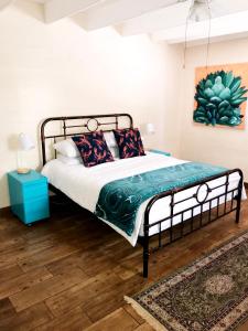 a bedroom with a bed and a painting on the wall at Self Catering Saldanha House in Saldanha