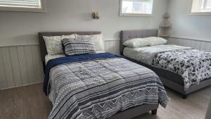 a bedroom with two beds and a bedskirts at Amazing property to Enjoy. in Stouffville