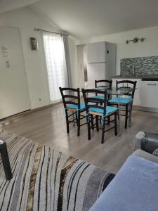 a room with a table and chairs and a kitchen at Appartements Au Cros De Cagnes in Cros-de-Cagnes
