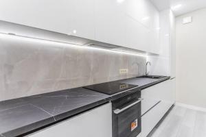 a kitchen with a stainless steel counter top at Vas’ apartment in Chişinău