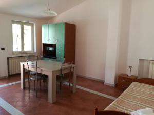 a kitchen with a table and chairs in a room at Grecale in Centola