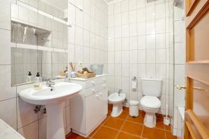 ポルトにあるCamarao Apartmentの白いバスルーム(洗面台、トイレ付)
