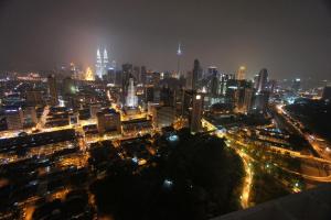 a city at night with skyscrapers and traffic lights at Amazing KLCC View @ Regalia Residence in Kuala Lumpur