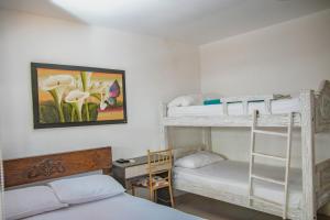a bedroom with two bunk beds and a desk at Hotel La Casona de Getsemani in Cartagena de Indias