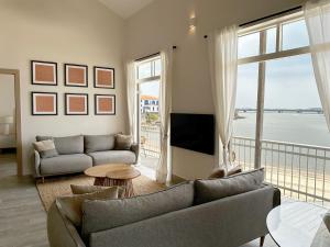 a living room with a couch and a large window at AmazINN Places Casa del Mar in Panama City