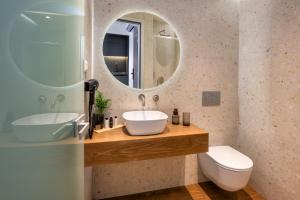 a bathroom with a sink and a mirror at Pelagus City - Deluxe Apartment I in Thessaloniki