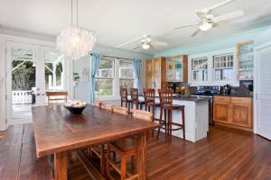 a kitchen and dining room with a wooden table and chairs at Hale Mahina in Kailua