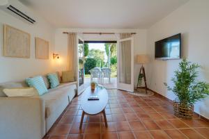 a living room with a couch and a table at Aura de Mar - Dúplex boutique cerca de la playa in Son Xoriguer +11 photos