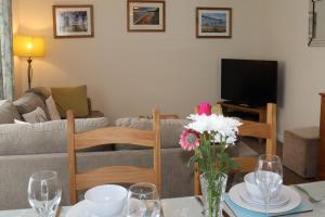 a living room with a couch and a table with flowers at Willow-Oak in Seaview +55 photos