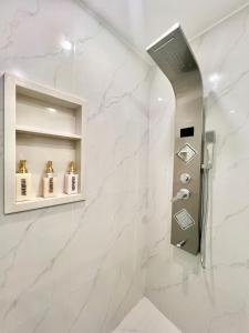 Renovated Rooms 10-min to Finch Subway Near Yonge St في تورونتو: حمام به دش وبجدران من الرخام الأبيض