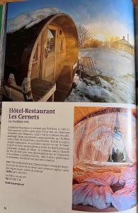 un artículo de revista con una foto de una tienda de campaña en Hôtel Restaurant Les Cernets Swiss-Lodge SSH en Les Verrières