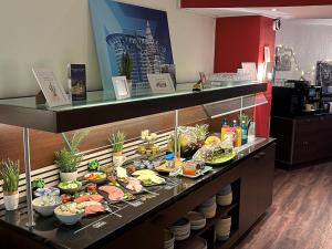 a buffet line with plates of food on display at Villa Hotel Frankfurt by MZ HotelCollection in Frankfurt/Main