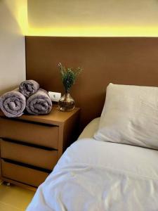 a bedroom with a bed and a vase with towels at Sua casa em Foz, localização incrível in Foz do Iguaçu