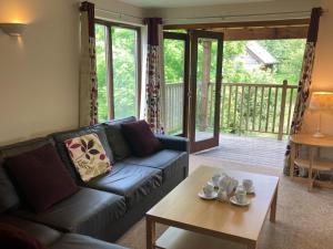 a living room with a couch and a coffee table at Water Mill Vacations Goldfinch - Dog Friendly in Newport +39 photos