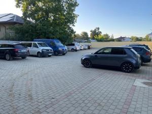a bunch of cars parked in a parking lot at Pensiunea Bianca in Botoşani