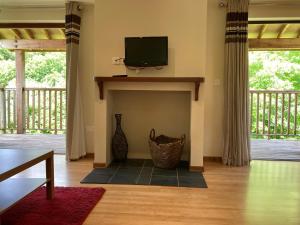 a living room with a fireplace with a flat screen tv at Water Mill Vacations Badgers Oak - Pet Friendly in Newport