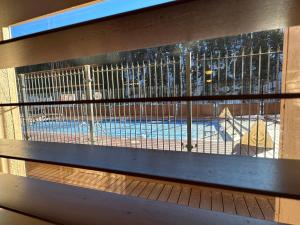 a view of a swimming pool through a fence at Lifts West G8 in Red River