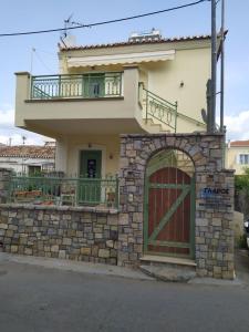 a house with a gate and a balcony at Glaros in Ermioni