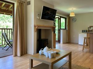 a living room with a table and a fireplace at Water Mill Vacations Kingfisher in Newport
