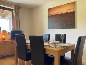 a dining room with a wooden table and chairs at Water Mill Vacations Kingfisher in Newport