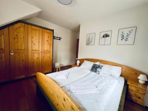 sypialnia z dużym łóżkiem z drewnianą ramą w obiekcie Alpenliebe w mieście Bad Kleinkirchheim
