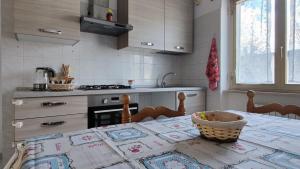 a kitchen with a table with a basket on it at La Tana della Volpe in Tempera