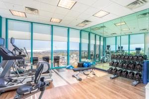 a gym with glass walls and treadmills at Holiday Inn Express Pensacola Beach, an IHG Hotel in Pensacola Beach