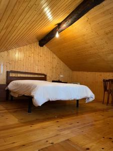 a bed in a room with a wooden ceiling at Casa Rural Miraval 