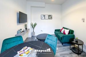 a living room with a couch and a table at Stylish Ensuite Room - Superfast Wi-fi 250mbps in Manchester