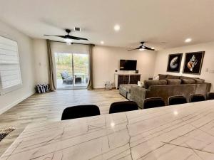a large living room with a couch and a table at Love Shack in Foley/ Hot Tub / Modern Cozy in Foley