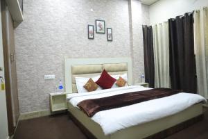 a bedroom with a large bed with red pillows at Seth Residency near Golden Temple in Amritsar