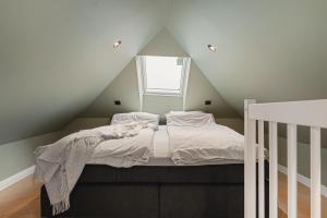 a bedroom with a bed in a attic at Bryggen // Fløyen Apartments in Bergen