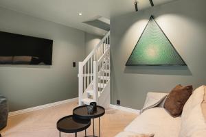 a living room with a couch and a pyramid on the wall at Bryggen // Fløyen Apartments in Bergen