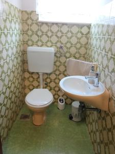 a bathroom with a toilet and a sink at Apartment Tea 1 in Okrug Donji +15 photos