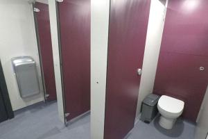 a bathroom stall with a toilet and a sink at Campsie Glen Holiday Park in Glasgow