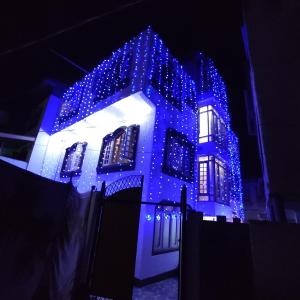 a house with blue lights on the side of it at Hotel Fabulous Kashmir in Srinagar