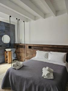 a bedroom with a bed with towels on it at Binario1 Rooms in Barletta