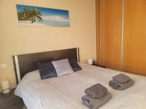 a bedroom with a bed with towels on it at Beautiful Apartment in La Manga in San Javier