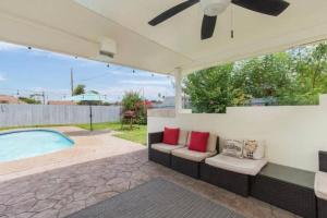 a patio with two chairs and a pool at McAllen 4BR with Pool, Shopping & More in McAllen