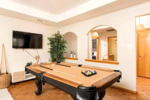 a pool table in a living room with a tv at McAllen 4BR with Pool, Shopping & More in McAllen
