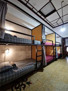 a room with three bunk beds in it at SEMERU HOSTEL MALANG in Malang